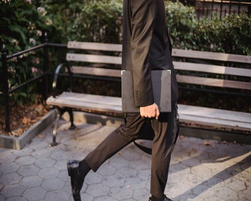 A professional man walking in a city park taking a healthy lifestyle break during a stressful day